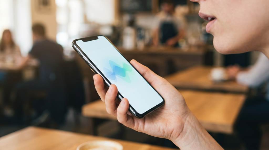 person using AI language app for pronunciation practice with speech recognition